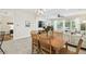 Living room and dining area with a large window, hardwood floors, and modern lighting at 16011 Bella Woods Dr, Tampa, FL 33647