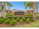 Community entrance sign surrounded by landscaped foliage and brick columns at 16011 Bella Woods Dr, Tampa, FL 33647