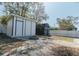 A backyard showing two storage sheds and a stone fire pit at 1605 Crown St, Clearwater, FL 33755