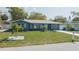 Charming single-story home featuring a well-manicured front yard and a classic exterior at 1605 Crown St, Clearwater, FL 33755