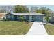 Well-maintained front yard with a long driveway leading to a cozy, single-story home at 1605 Crown St, Clearwater, FL 33755