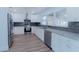 Modern kitchen with stainless steel appliances, granite countertops, and stylish backsplash at 1605 Crown St, Clearwater, FL 33755
