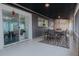 This is a covered patio, featuring a table with chairs, a rug, and a sliding door to the living room at 1605 Crown St, Clearwater, FL 33755