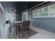 Screened lanai with outdoor dining, sliding glass doors to home, and black and white area rug at 1605 Crown St, Clearwater, FL 33755