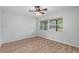 Empty bedroom with a ceiling fan and large window at 1881 Oak Park N Dr, Clearwater, FL 33764