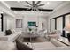 Inviting living room with beamed ceiling, neutral furniture, large windows, and sliding glass doors at 2011 Belleair Rd, Clearwater, FL 33764