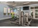 Gym with weight machine, medicine balls, and a mounted television for entertainment at 20381 Symphony Pl, Venice, FL 34293