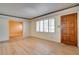 Bright living room featuring hardwood floors, plantation shutters, and a classic wood door at 2448 14Th S Ave, St Petersburg, FL 33712