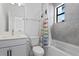 Modern bathroom featuring tub, shower, toilet and vanity with sink, modern fixtures and grey tile at 2511 N Grady Ave # 2, Tampa, FL 33607