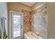 Bathroom features shower with glass door, tiled walls, and access door to exterior at 2926 Spring Hammock Dr, Plant City, FL 33566