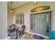 Charming front porch with seating area, decorative door, and attractive exterior lighting at 2926 Spring Hammock Dr, Plant City, FL 33566