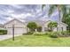 Charming single-story home featuring a well-manicured lawn and lush landscaping at 2926 Spring Hammock Dr, Plant City, FL 33566