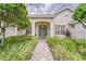 Inviting home exterior with a well-manicured lawn, walkway, and lush landscaping at 2926 Spring Hammock Dr, Plant City, FL 33566