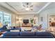 Comfortable living room features hardwood floors, ceiling fan and sliding glass doors to lanai at 2926 Spring Hammock Dr, Plant City, FL 33566