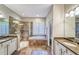 Main bathroom features double sinks, a glass enclosed shower, and a soaking tub at 2926 Spring Hammock Dr, Plant City, FL 33566