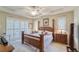 Main bedroom features a ceiling fan, shuttered windows, and a comfortable bed at 2926 Spring Hammock Dr, Plant City, FL 33566