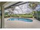Screened-in pool with ample patio space surrounded by green landscaping at 2926 Spring Hammock Dr, Plant City, FL 33566