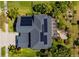 Aerial view of home featuring a solar panel system, screened-in lanai and lush landscaping at 309 Royal Bonnet Dr, Apollo Beach, FL 33572
