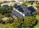 Aerial view of the house featuring solar panels, screened in patio and lush landscaping at 309 Royal Bonnet Dr, Apollo Beach, FL 33572