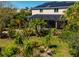 Beautiful backyard with a screened-in lanai, and solar panels on the roof of the home at 309 Royal Bonnet Dr, Apollo Beach, FL 33572