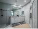 Bright bathroom featuring double sinks, a granite countertop, and a glass-enclosed shower at 309 Royal Bonnet Dr, Apollo Beach, FL 33572