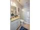 Well-lit bathroom featuring a sleek glass-enclosed shower and a modern vanity with granite countertops at 309 Royal Bonnet Dr, Apollo Beach, FL 33572