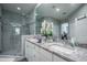 Bright bathroom featuring double sinks, a granite countertop, and a glass-enclosed shower at 309 Royal Bonnet Dr, Apollo Beach, FL 33572