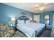 Spacious primary bedroom with blue walls, a large bed, and decorative accents at 309 Royal Bonnet Dr, Apollo Beach, FL 33572
