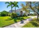 Beautiful two-story home featuring manicured lawn, lush landscaping, and a charming curb appeal at 309 Royal Bonnet Dr, Apollo Beach, FL 33572