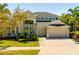 Stately home featuring well manicured landscaping, a large driveway and a three-car garage at 309 Royal Bonnet Dr, Apollo Beach, FL 33572