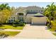 Elegant home with well manicured landscaping, ample parking, and a spacious three-car garage at 309 Royal Bonnet Dr, Apollo Beach, FL 33572