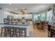 A spacious kitchen with granite countertops, an island, and modern stainless steel appliances and an adjacent breakfast area at 309 Royal Bonnet Dr, Apollo Beach, FL 33572
