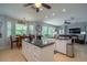 Open-concept kitchen featuring a granite island, stainless appliances, and seamless flow to the dining and living areas at 309 Royal Bonnet Dr, Apollo Beach, FL 33572