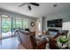 Bright living room boasting a large sliding glass door, comfortable seating, and a modern television at 309 Royal Bonnet Dr, Apollo Beach, FL 33572