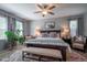 Serene main bedroom with a king bed, soft lighting, and large windows offering natural light at 309 Royal Bonnet Dr, Apollo Beach, FL 33572