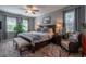 Serene main bedroom with a king bed, soft lighting, and large windows offering natural light at 309 Royal Bonnet Dr, Apollo Beach, FL 33572