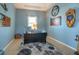 A bright and well decorated home office features a large area rug and neutral blue walls at 309 Royal Bonnet Dr, Apollo Beach, FL 33572