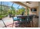 Covered outdoor patio features comfortable seating and a tranquil garden view with lush landscaping at 309 Royal Bonnet Dr, Apollo Beach, FL 33572