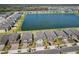 An aerial view features residential homes surrounding a lake in a planned community at 3139 Marine Grass Dr, Wimauma, FL 33598