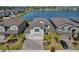 An aerial view showcases the beautiful home and its proximity to the lake, surrounded by well-maintained landscaping at 3139 Marine Grass Dr, Wimauma, FL 33598