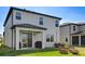 This home's backyard has a covered patio, sliding glass door and a fire pit seating area at 3139 Marine Grass Dr, Wimauma, FL 33598