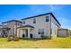The home's backyard features a covered patio and a cozy fire pit seating area at 3139 Marine Grass Dr, Wimauma, FL 33598
