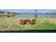 A relaxing backyard seating area with beautiful water views provides a peaceful retreat at 3139 Marine Grass Dr, Wimauma, FL 33598