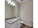 Powder room with white vanity, granite counters, and wood-look tile flooring at 3139 Marine Grass Dr, Wimauma, FL 33598