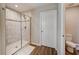 Modern bathroom featuring a glass shower with decorative tile work and wood look tile flooring at 3139 Marine Grass Dr, Wimauma, FL 33598