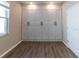Bright bedroom features a wall of built-in storage cabinets and wood-look tile flooring at 3139 Marine Grass Dr, Wimauma, FL 33598