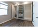 Bedroom with open closet featuring shelving, drawers and wood-look tile flooring at 3139 Marine Grass Dr, Wimauma, FL 33598