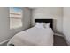 Cozy bedroom featuring a black headboard and bright natural light from the window at 3139 Marine Grass Dr, Wimauma, FL 33598