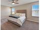Well lit bedroom with a ceiling fan, neutral tones, plush carpeting, and two bright windows at 3139 Marine Grass Dr, Wimauma, FL 33598