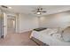 Bedroom boasts neutral carpeting, a ceiling fan, and an ensuite bathroom access at 3139 Marine Grass Dr, Wimauma, FL 33598